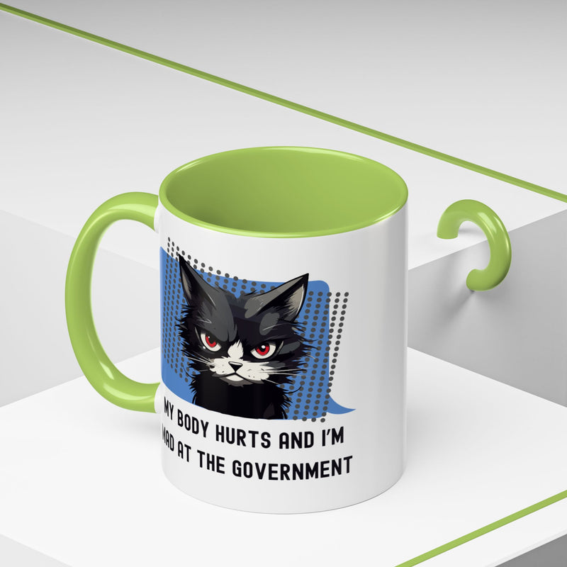 11 oz Coffee and Tea Mug — "My Body Hurts and I'm Mad at the Government" Sassy Cat Accent Mug