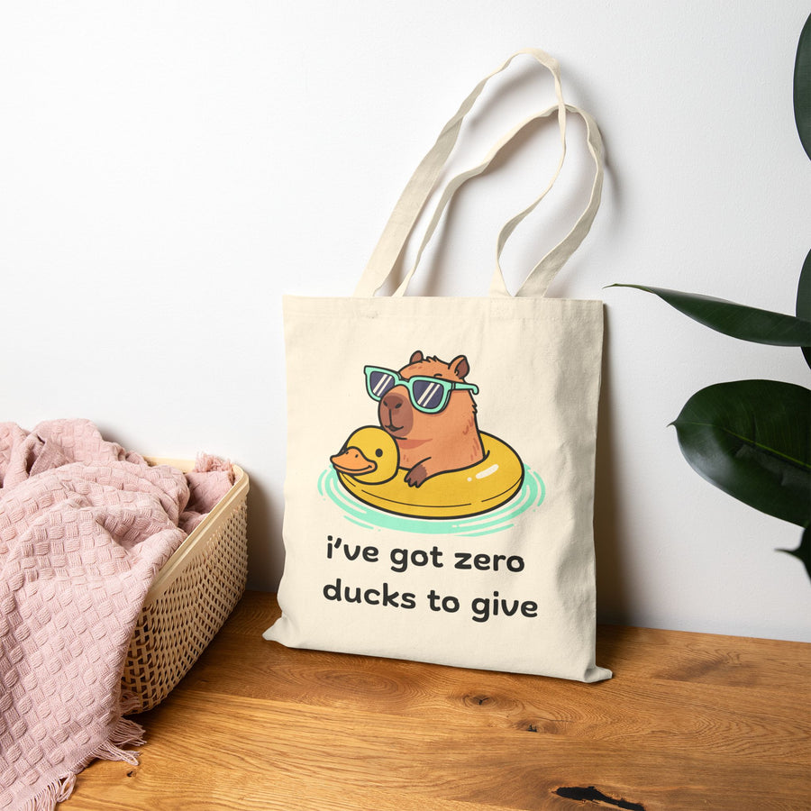 Canvas Tote Bag —Capybara Float with Rubber Duck “I’ve Got Zero Ducks to Give”