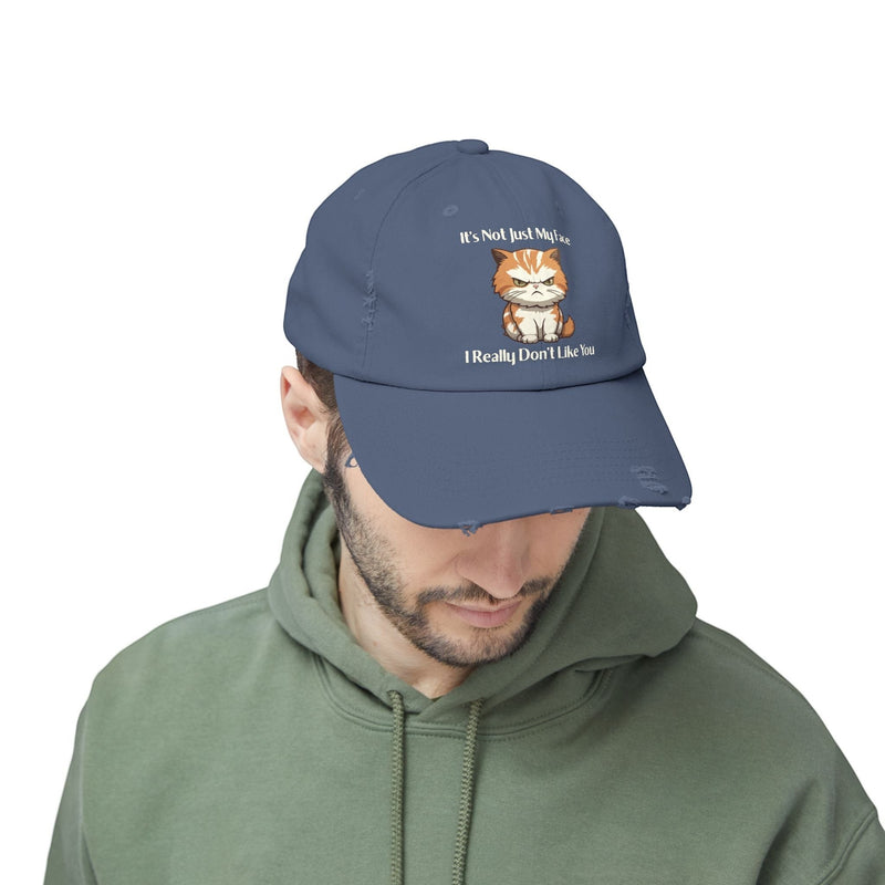 Ironically Inked blue distressed cotton cap featuring a grumpy orange kitten graphic and cheeky text on a man