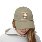 Ironically Inked distressed cotton twill cap featuring a grumpy orange kitten graphic and cheeky text on a beige hat.