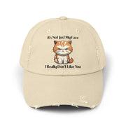 Ironically Inked distressed beige cotton cap featuring a grumpy orange kitten graphic and cheeky text.