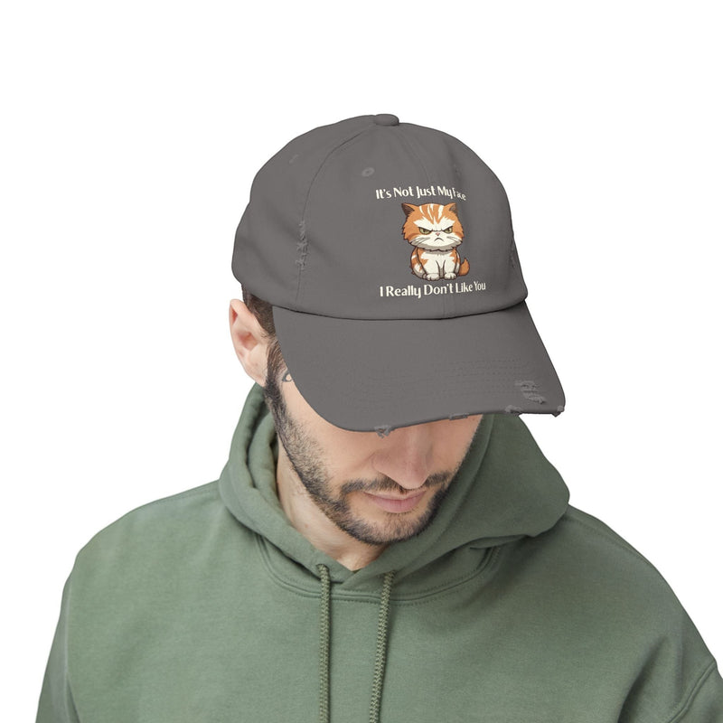 Ironically Inked distressed grey cotton cap featuring a grumpy orange kitten graphic and cheeky text on a man.