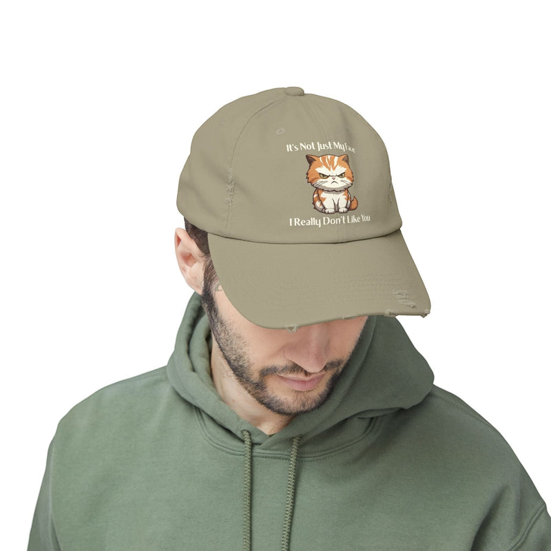 Ironically Inked distressed cotton twill cap in olive green featuring a grumpy orange kitten and cheeky text.