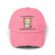 Ironically Inked pink distressed cotton twill cap featuring a grumpy orange kitten and cheeky text graphic.