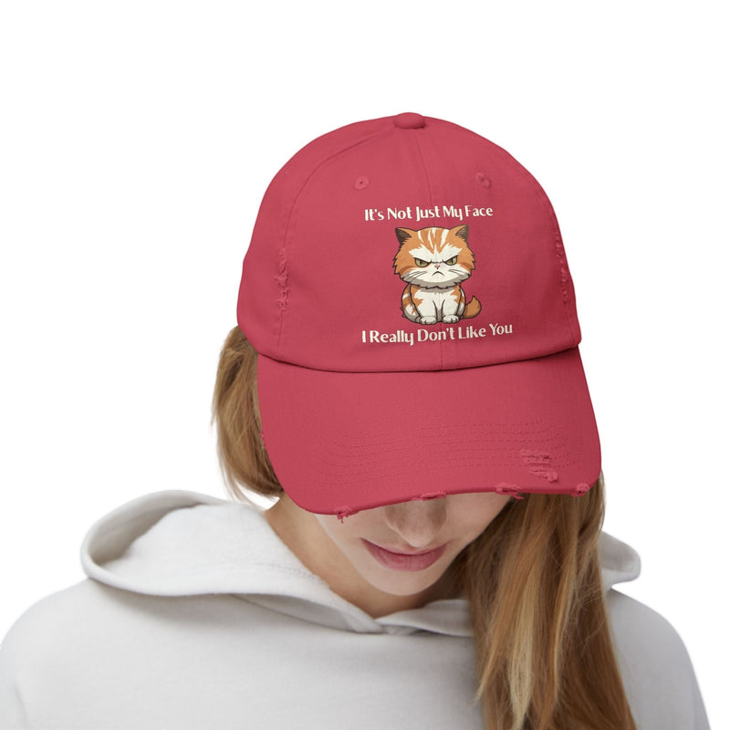 Ironically Inked red distressed cotton twill cap featuring a grumpy orange kitten graphic and cheeky text.